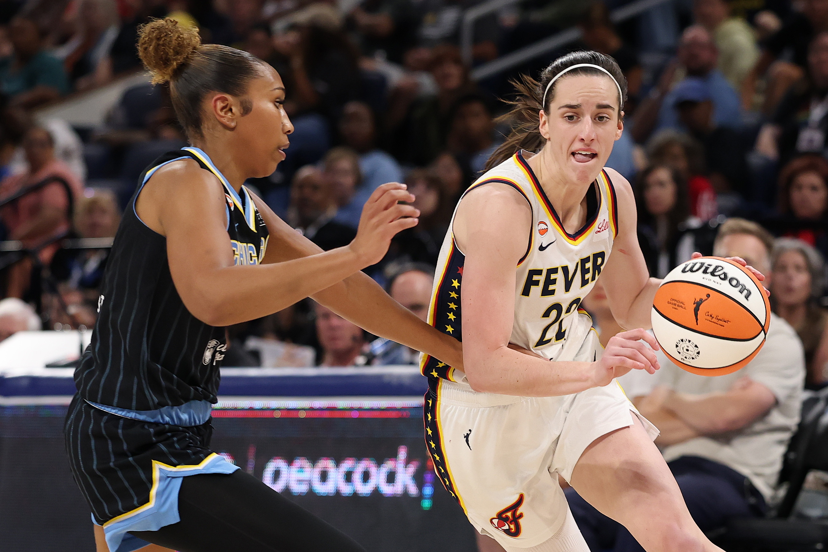 Caitlin Clark of the Indiana Fever, right, drives to the basket against Sydney Taylor of the Chicago Sky on Aug. 23.